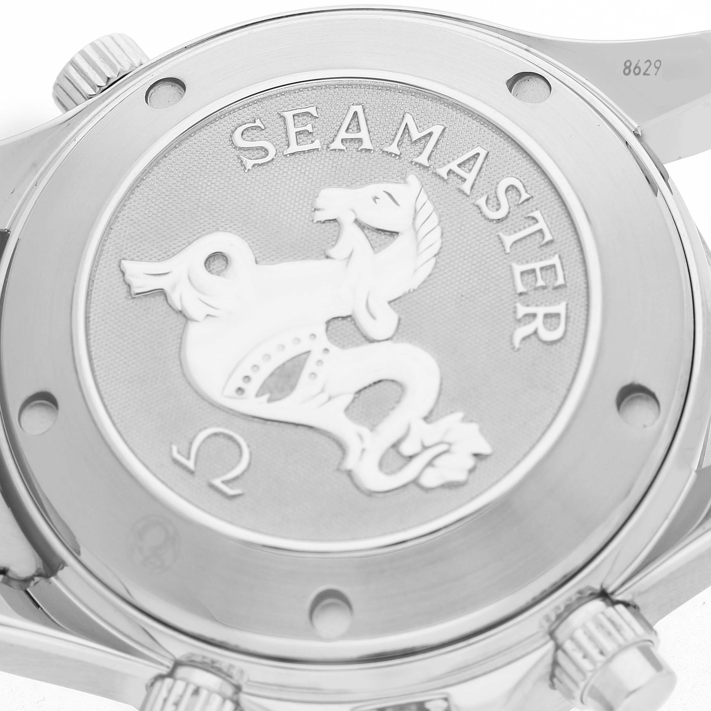 The image shows the back of an Omega Seamaster 2225.80.00 Men's Stainless Steel Blue Dial watch, featuring its engraved emblem and caseback detailing.