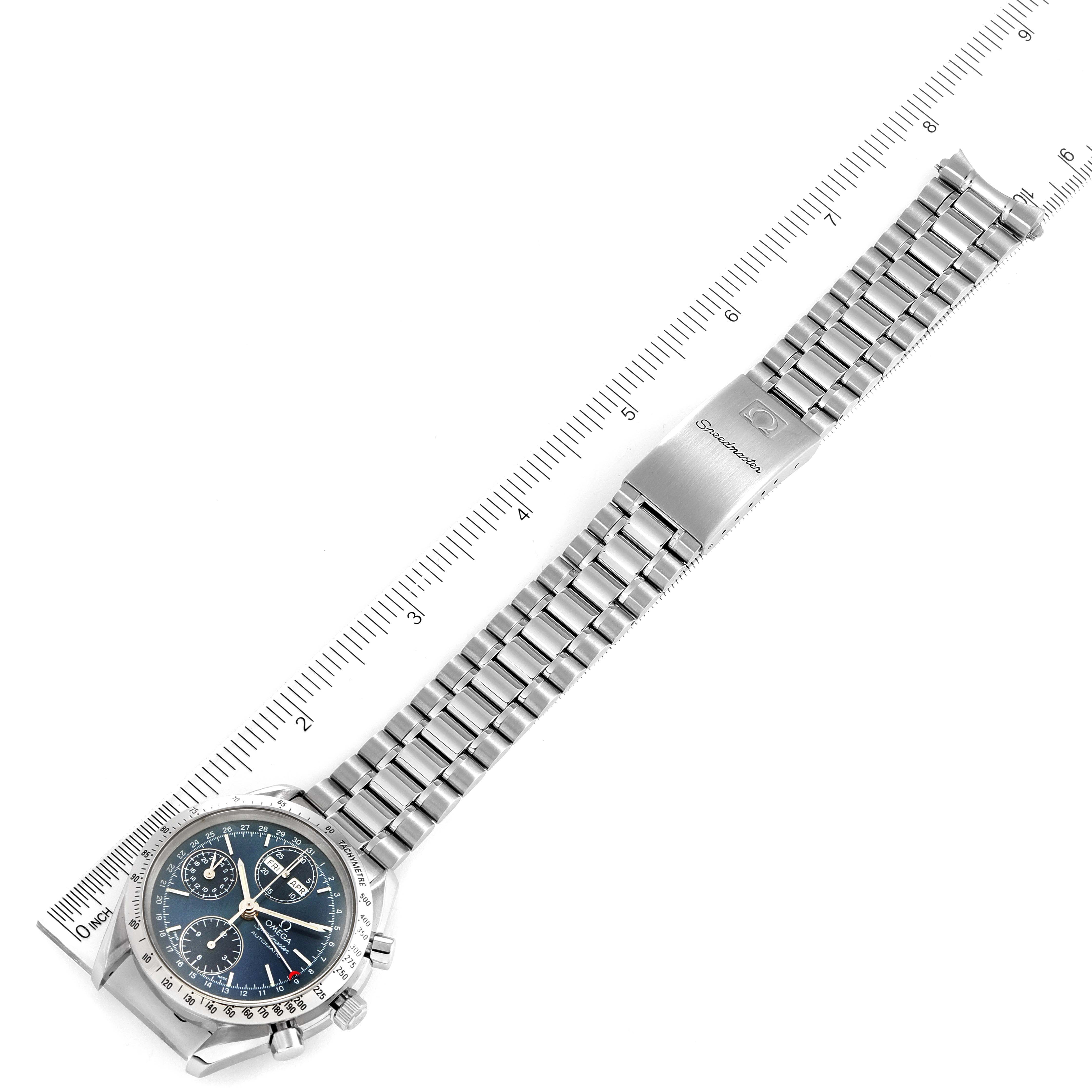 This image shows an Omega Speedmaster 3521.80.00 Men
s Stainless Steel Blue Dial 3521.80.00 Men
s Stainless Steel Blue Dial watch with a stainless steel bracelet, positioned next to a ruler for scale.