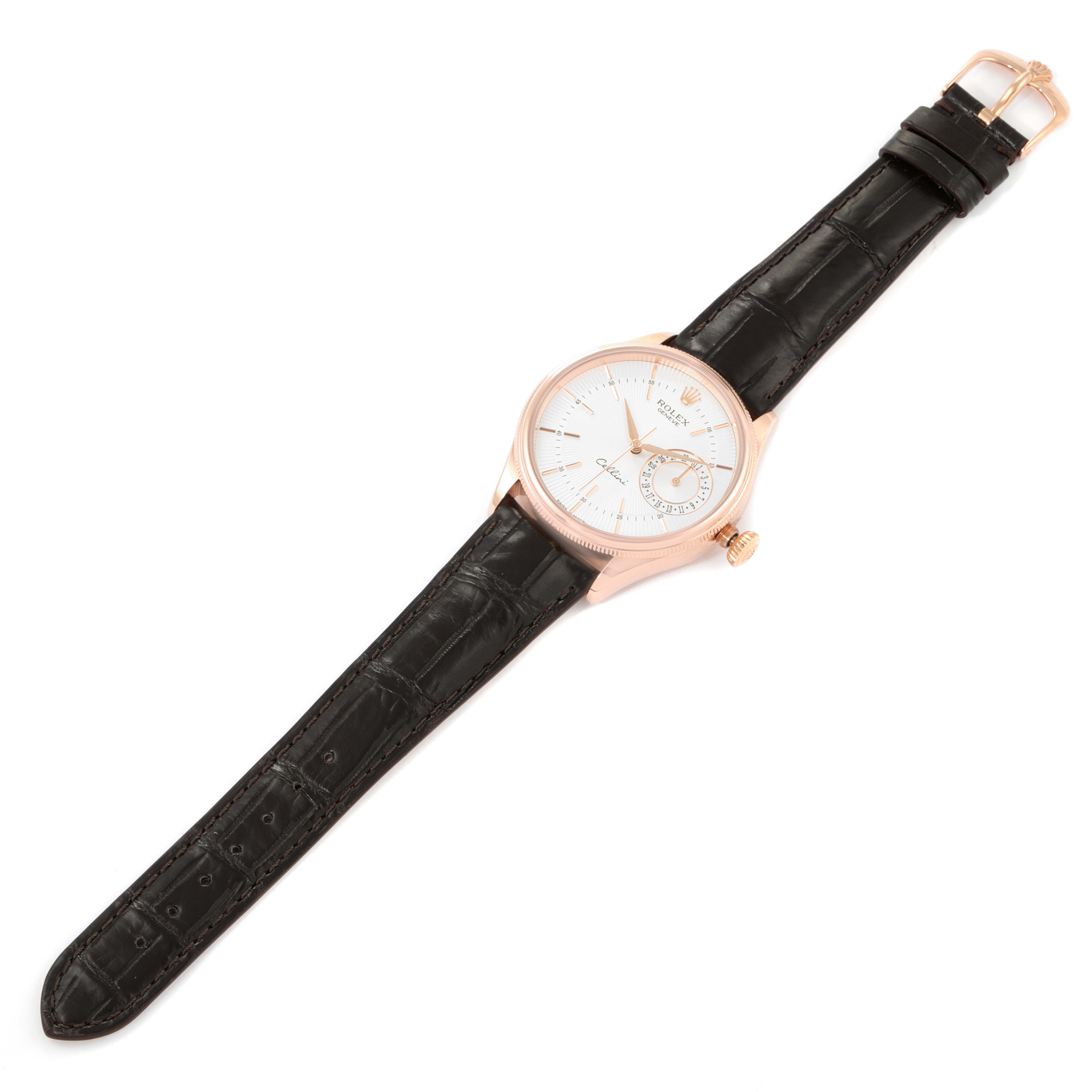 The Rolex Cellini 50515 Men's Rose Gold Silver Dial 50515 Men's Rose Gold Silver Dial watch is shown lying flat, displaying its face, black leather strap, and rose gold-toned case.