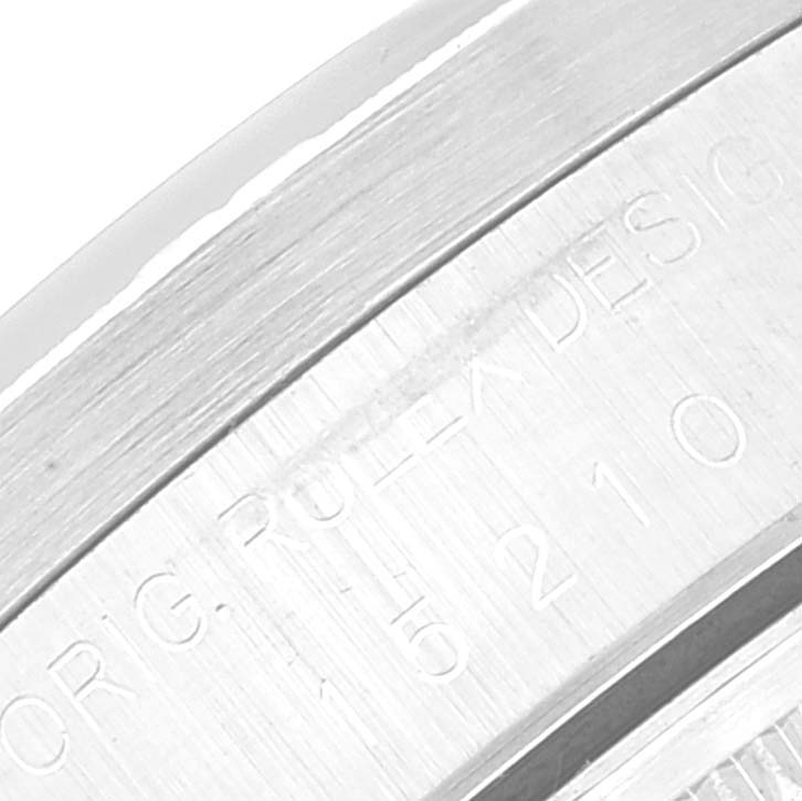 The image is a close-up shot of the edge of a Rolex Date 15210 Men's Stainless Steel Black Dial 15210 Men's Stainless Steel Black Dial model watch, showing engraved text on the inner bezel.