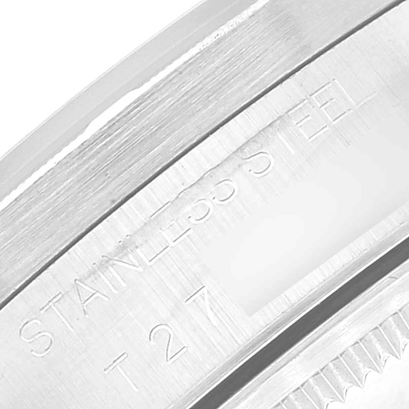 The image shows a close-up angle of the side of the casing, highlighting the "STAINLESS STEEL" engraving on the Rolex Date 15210 Men's Stainless Steel Black Dial 15210 Men's Stainless Steel Black Dial model.