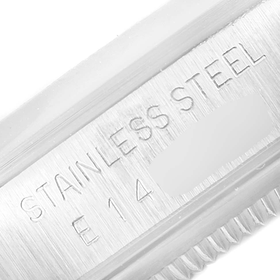 The image shows a close-up of the serial number and "STAINLESS STEEL" engraving on a Rolex Date 15200 Men's Stainless Steel Silver Dial 15200 Men's Stainless Steel Silver Dial model watch case.