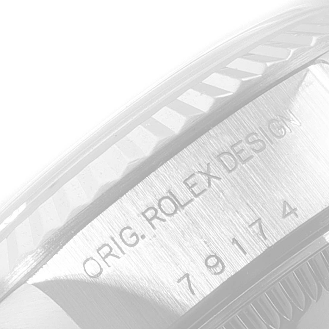 The image shows a close-up angle of the case side of a Rolex Datejust 79174 Women's Stainless Steel Black Dial 79174 Women's Stainless Steel Black Dial watch, highlighting its engraved design and part of the bezel.