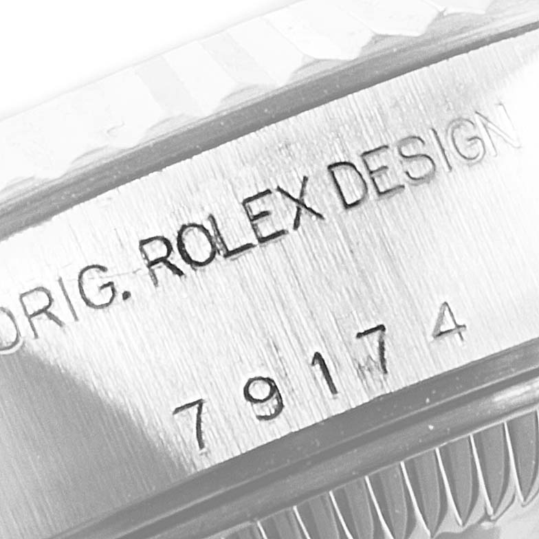 This image shows the engraved model number and "ORIG. ROLEX DESIGN" on the side of the Rolex Datejust 79174 Women's Stainless Steel Black Dial 79174 Women's Stainless Steel Black Dial watch case.