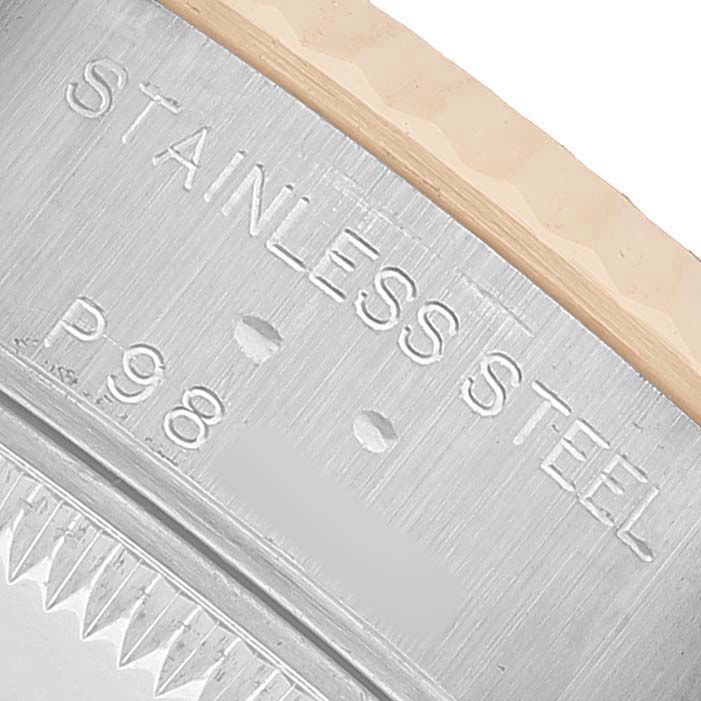 This close-up image shows the engraved text on the stainless steel case side of a Rolex Datejust 79173 Women's Steel and Gold (two tone) Black Dial model.