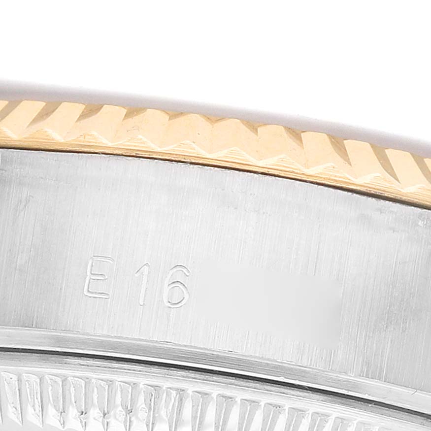 The image shows a close-up of the Rolex Datejust 69173 Women's Steel and Gold (two tone) Champagne Dial's fluted bezel and side case with engraving.