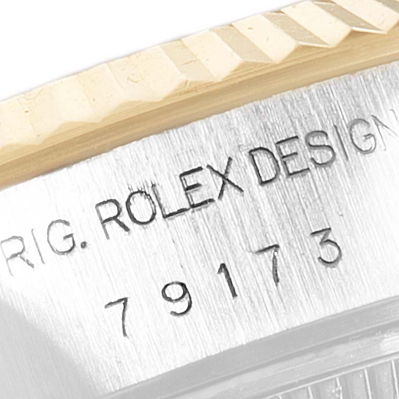 This image shows a close-up of the bezel and serial number engraving on a Rolex Datejust 79173 Women's Steel and Gold (two tone) White Dial 79173 Women's Steel and Gold (two tone) White Dial watch.
