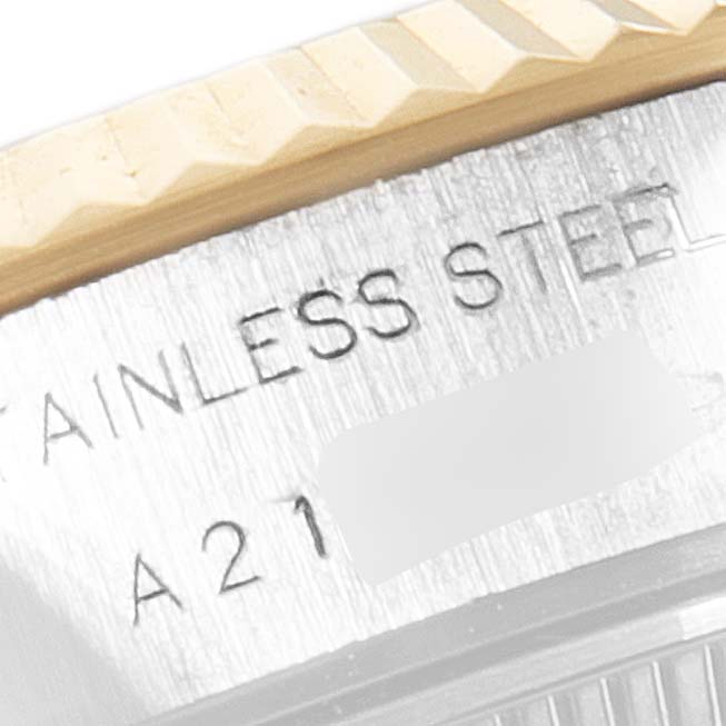 This image shows a close-up of the case back of a Rolex Datejust 79173 Women's Steel and Gold (two tone) White Dial 79173 Women's Steel and Gold (two tone) White Dial, highlighting the stainless steel marking and the fluted bezel.