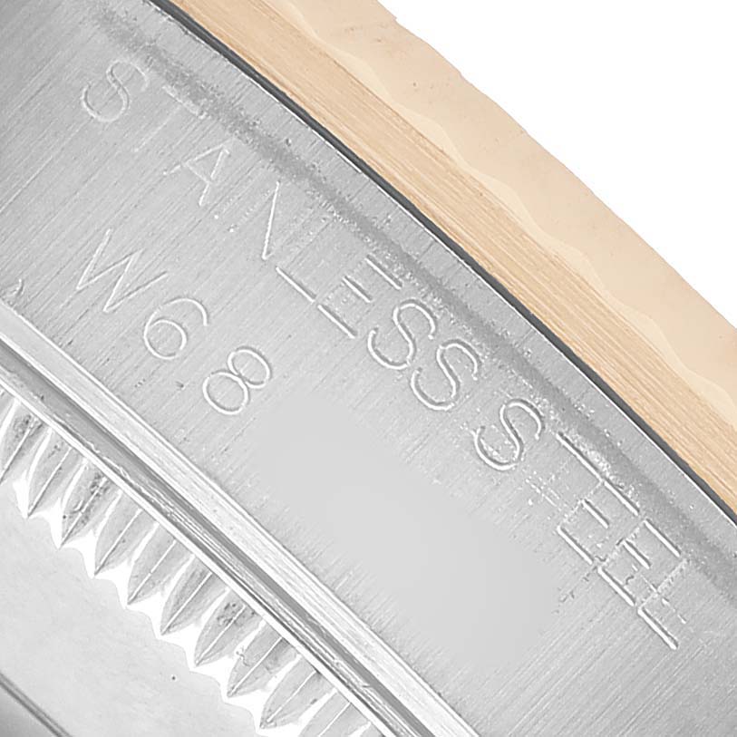 The image shows a close-up of the Rolex Datejust 68273 Women's Steel and Gold (two tone) White Dial model's stainless steel case side with engraved text.