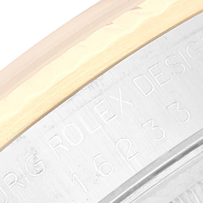 This image shows a close-up of the side engraving and bezel of a Rolex Datejust 16233 Men's Steel and Gold (two tone) Champagne Dial 16233 Men's Steel and Gold (two tone) Champagne Dial model watch.