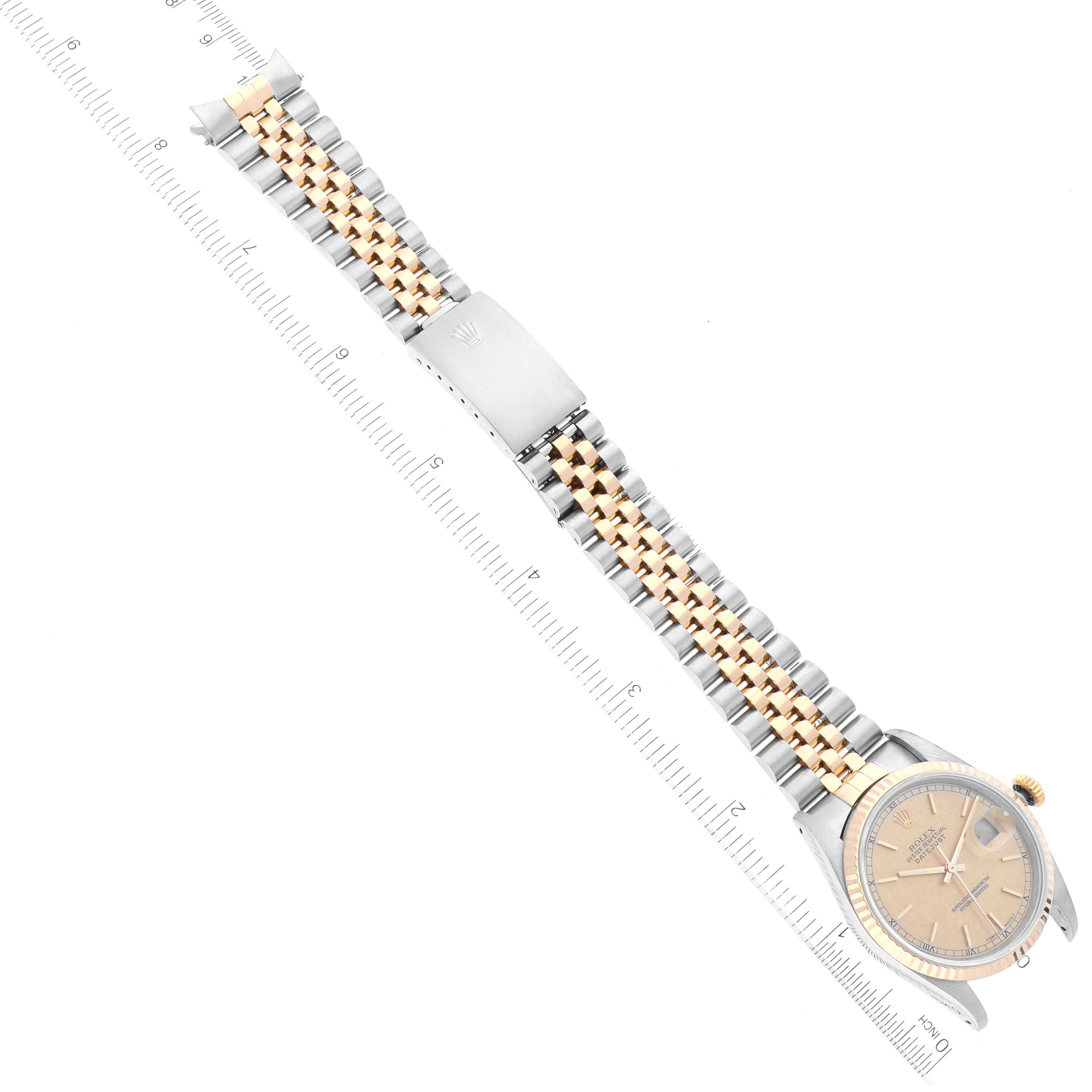 This top-down view of the Rolex Datejust 16233 Men's Steel and Gold (two tone) Champagne Dial 16233 Men's Steel and Gold (two tone) Champagne Dial watch shows the face and two-tone metal bracelet.