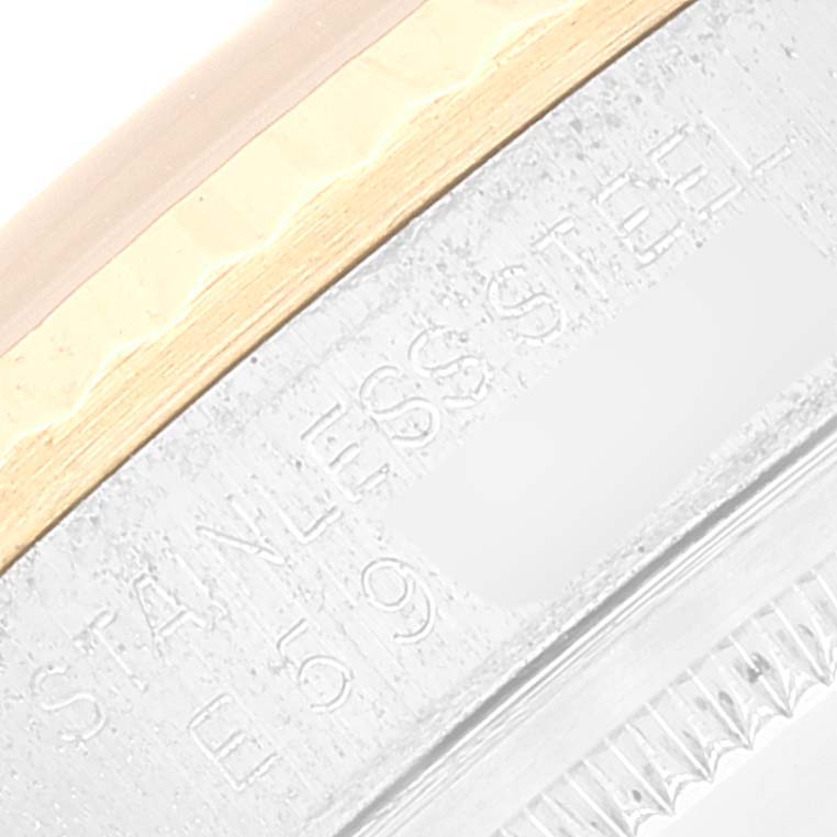 This image shows a close-up of the engraving on the side of a Rolex Datejust 16233 Men's Steel and Gold (two tone) Champagne Dial 16233 Men's Steel and Gold (two tone) Champagne Dial model watch case.