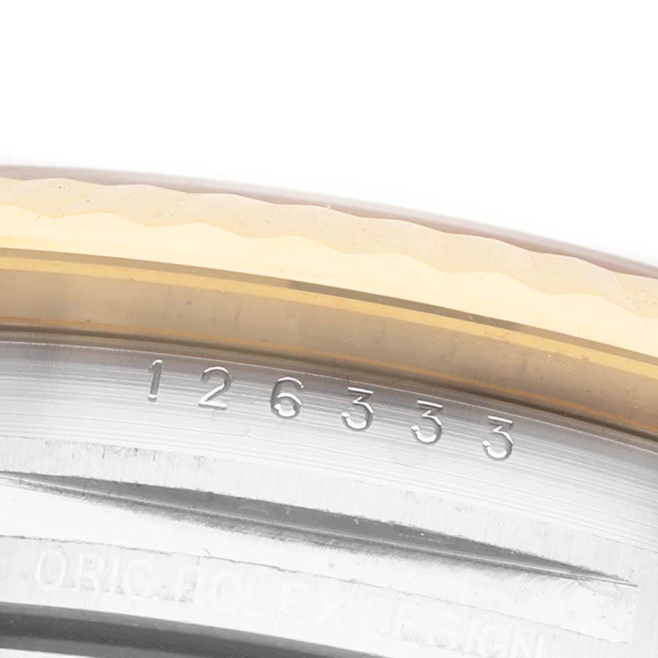 The image shows a close-up angle of the Rolex Datejust 126333 Men's Steel and Gold (two tone) Grey Dial's bezel and serial number inscribed on the side.