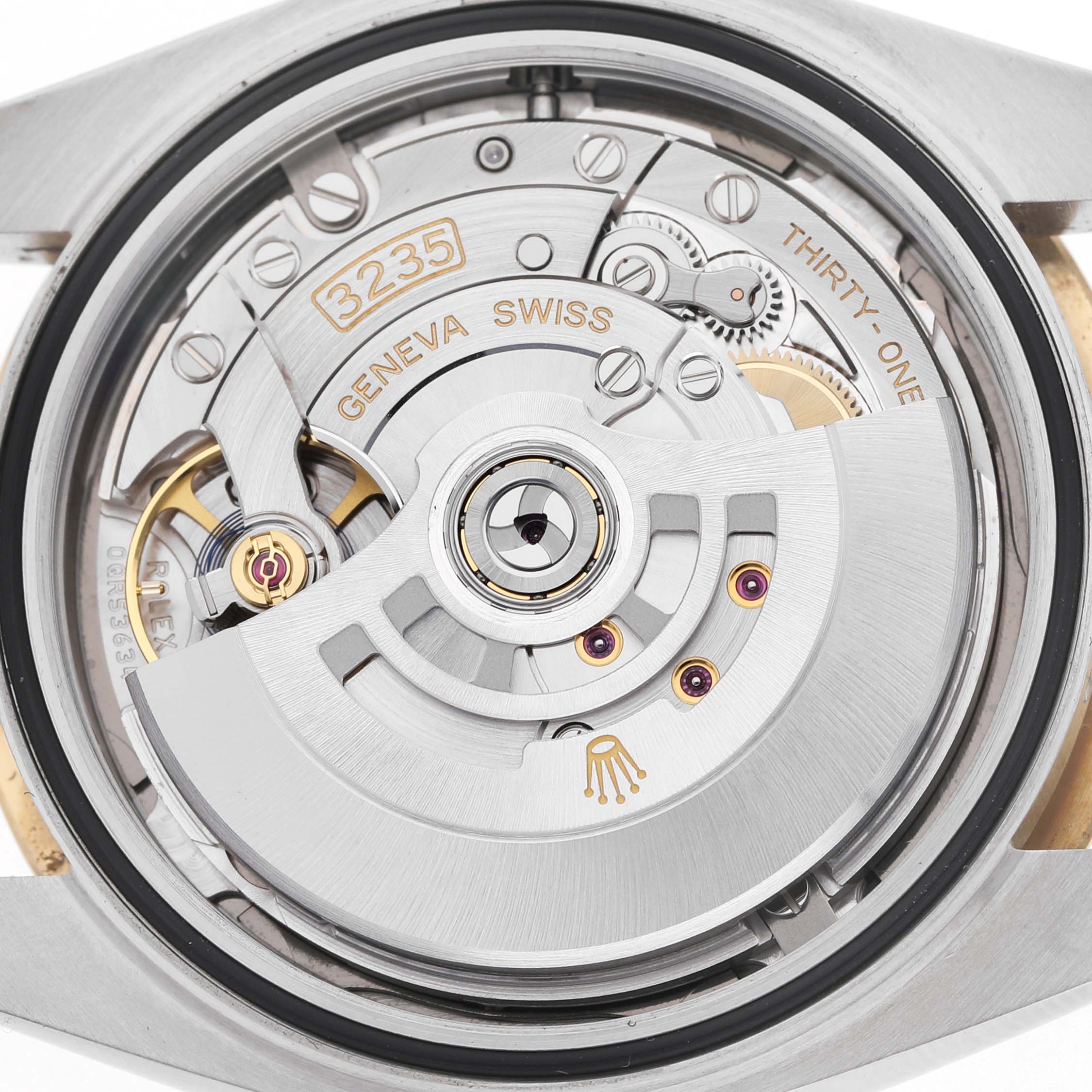 The image shows the movement of a Rolex Datejust 126333 Men's Steel and Gold (two tone) Grey Dial watch from the back, highlighting the rotor and intricate mechanical parts.