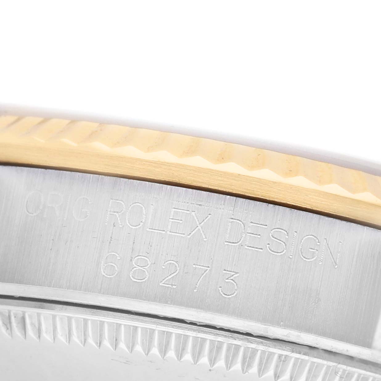 The image shows the side of a Rolex Mid-Size 68273 Women's Stainless Steel Beige Dial watch case, featuring engraved text and part of the bezel.