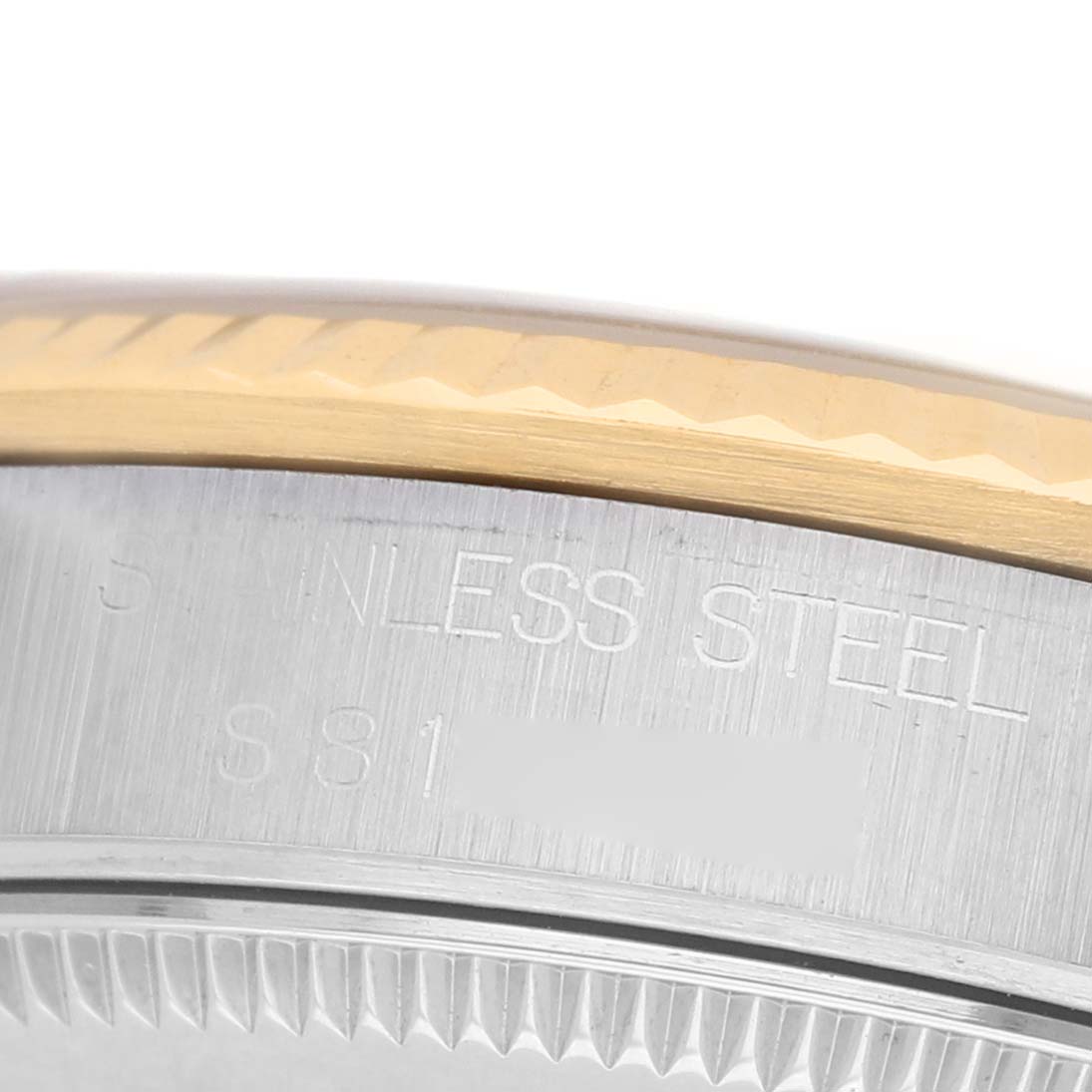 The image shows a close-up angle of a Rolex Mid-Size 68273 Women's Stainless Steel Beige Dial model's case back with "STAINLESS STEEL" engraved on it.