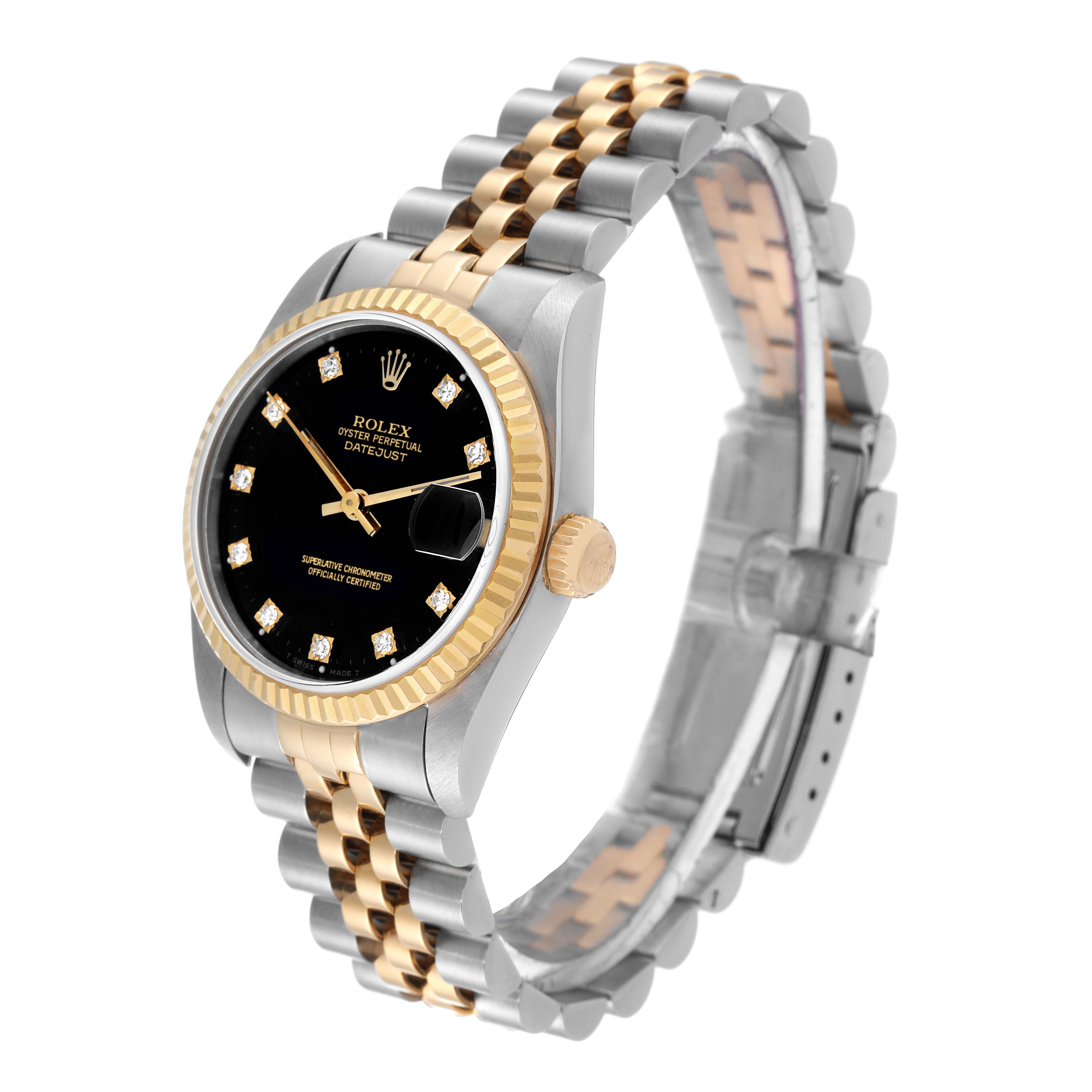 The image shows a side angle of a Rolex Mid-Size 68273 Women's Steel and Gold (two tone) Black Dial 68273 Women's Steel and Gold (two tone) Black Dial Datejust watch, highlighting its black dial, gold bezel, and two-tone bracelet.