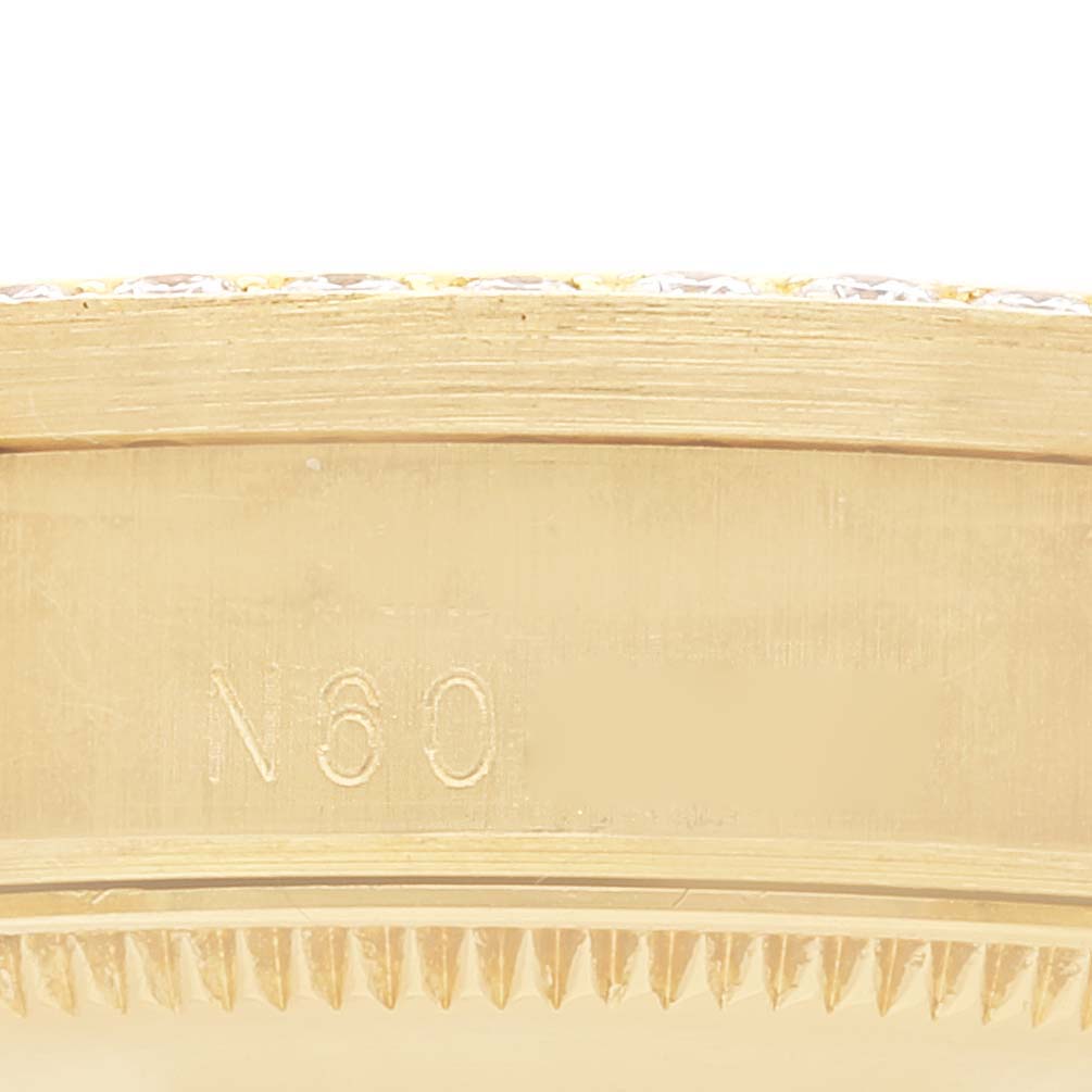 This image shows a close-up of the engraved side of a Rolex President 68158 Women
s Yellow Gold Champagne Dial 68158 Women
s Yellow Gold Champagne Dial model watch, focusing on the serial or model number.