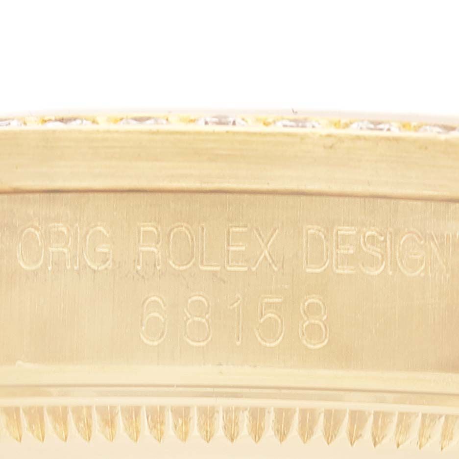 The image shows a close-up of the side engraving on a Rolex President 68158 Women
s Yellow Gold Champagne Dial 68158 Women
s Yellow Gold Champagne Dial model watch, including the design number "68158."
