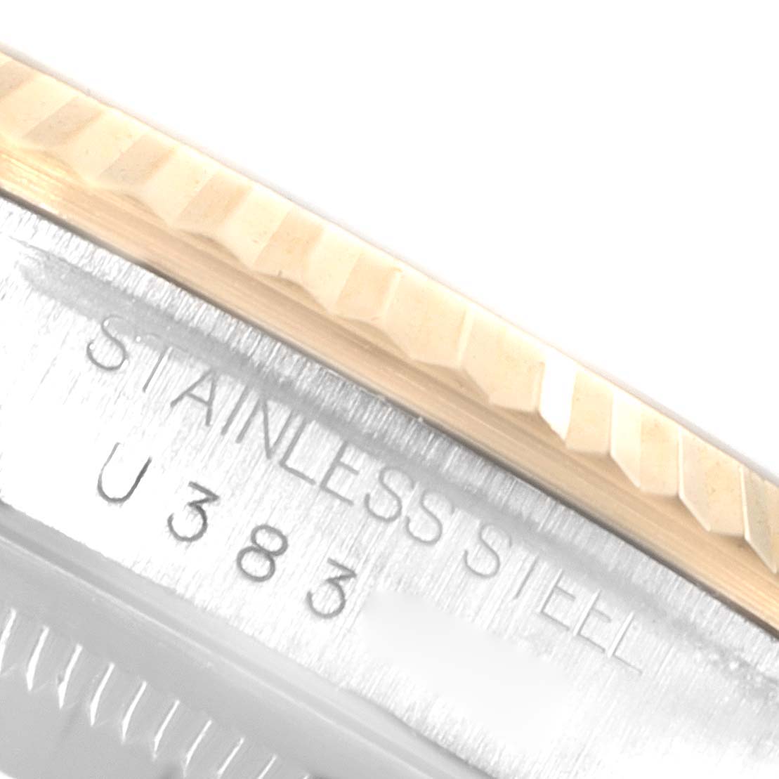 This image shows a close-up of the bezel and case side of a Rolex Datejust 16233 Men's Steel and Gold (two tone) Champagne Dial 16233 Men's Steel and Gold (two tone) Champagne Dial watch, highlighting the stainless steel engraving.
