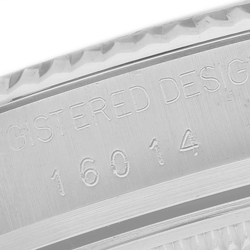 The image shows a close-up of the inner bezel with engravings on the Rolex Datejust 16014 Men's Stainless Steel Black Dial watch.