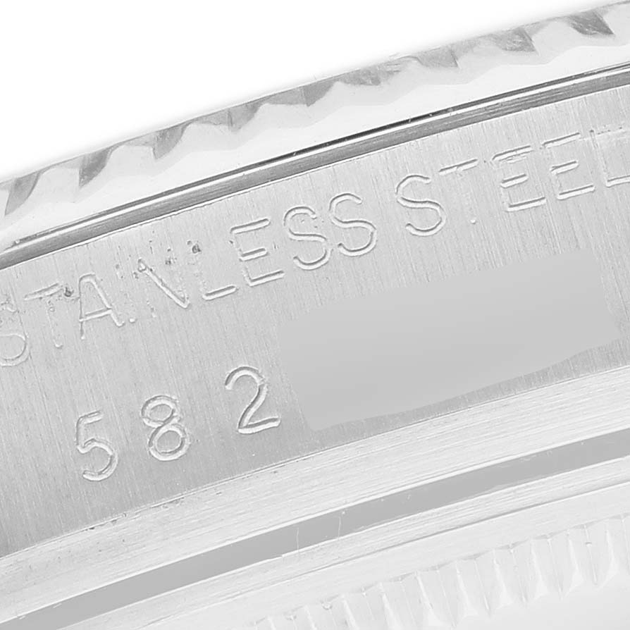 The image shows a close-up of the Rolex Datejust 16014 Men's Stainless Steel Black Dial watch's stainless steel case, focusing on the engraved text.