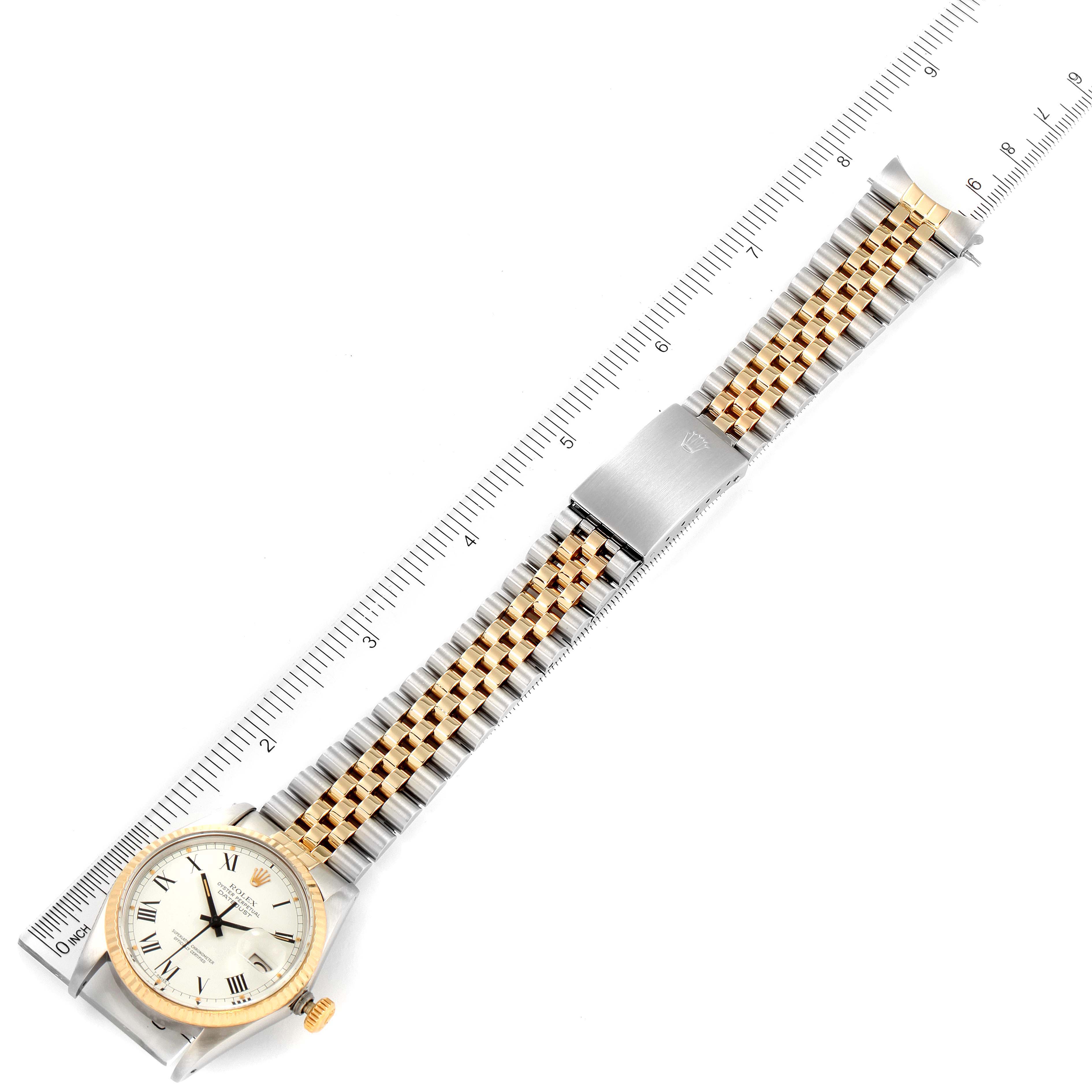The image shows a Rolex Vintage Collection 16013 Men's Steel and Gold (two tone) White Dial 16013 Men's Steel and Gold (two tone) White Dial watch laid flat with its full gold and silver band and face visible, alongside a measuring ruler.