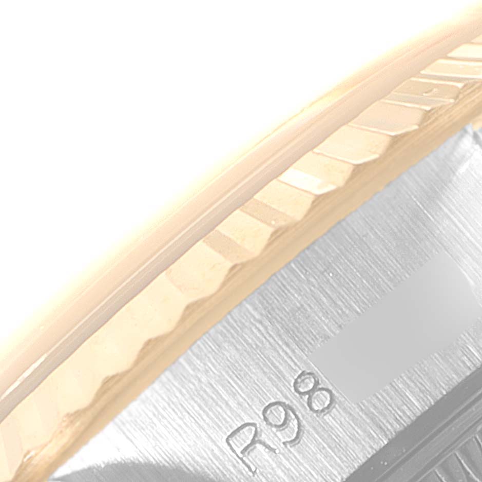 This image shows a close-up of the bezel and part of the case of a Rolex Datejust 69173 Women
s Steel and Gold (two tone) Champagne Dial 69173 Women
s Steel and Gold (two tone) Champagne Dial watch.