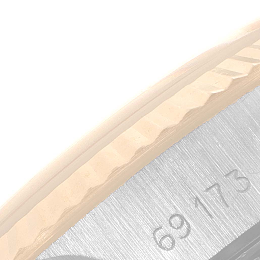 This image shows a close-up angle of the side case and bezel of a Rolex Datejust 69173 Women
s Steel and Gold (two tone) Champagne Dial 69173 Women
s Steel and Gold (two tone) Champagne Dial watch, revealing partial numerals.