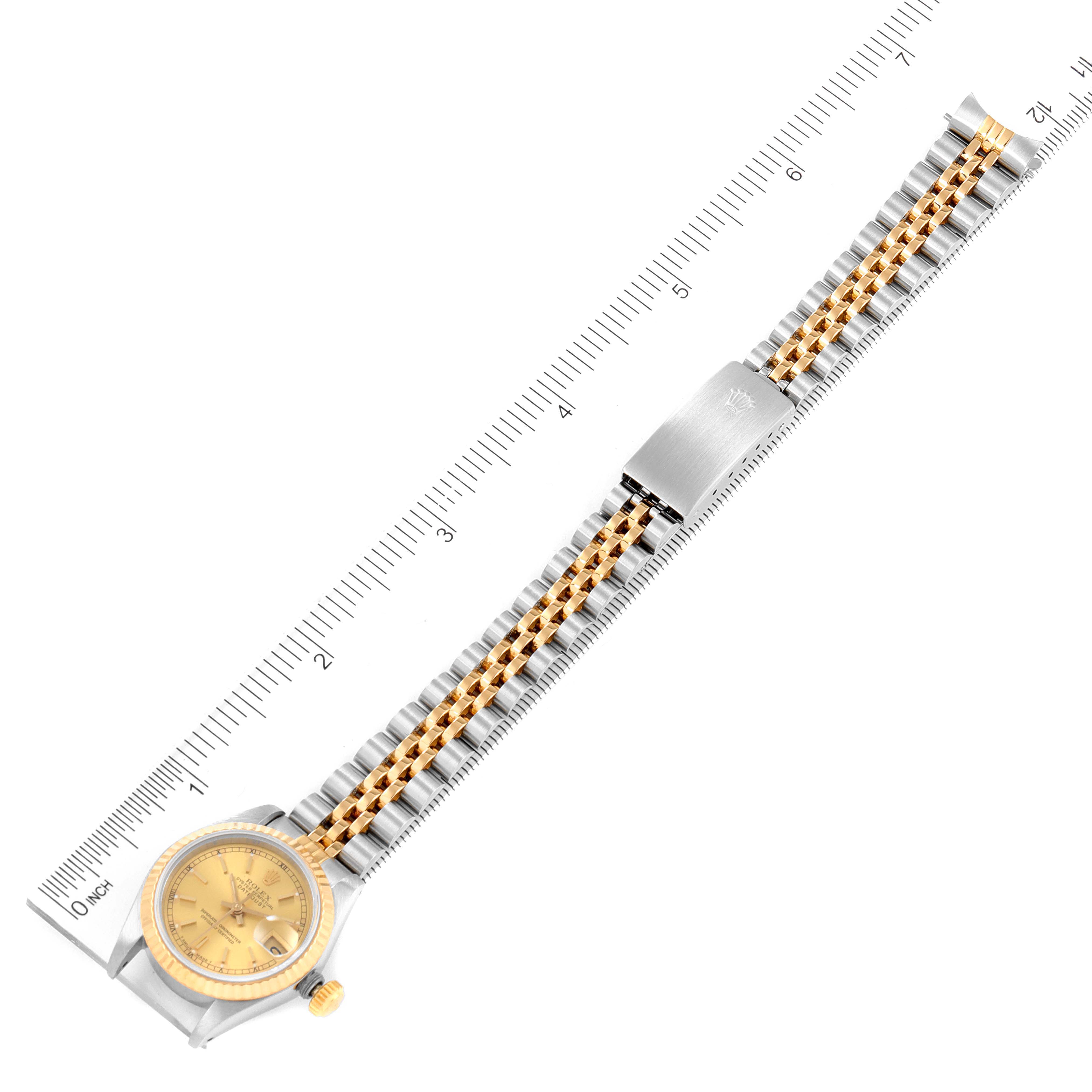 This image shows a full top-down view of a Rolex Datejust 69173 Women
s Steel and Gold (two tone) Champagne Dial 69173 Women
s Steel and Gold (two tone) Champagne Dial watch with a ruler for scale.