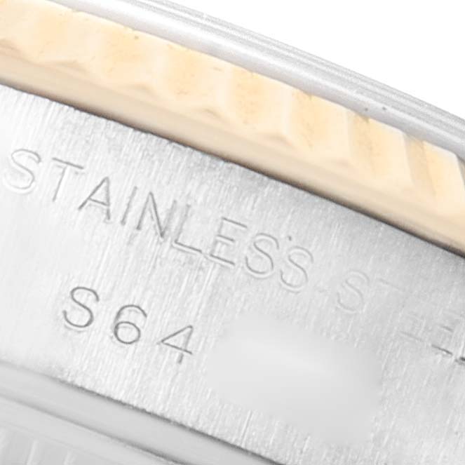 This image shows a close-up of the bezel and part of the case back, revealing stainless steel details and partial engravings of a Rolex Datejust 69173 Women's Steel and Gold (two tone) White Dial 69173 Women's Steel and Gold (two tone) White Dial watch.