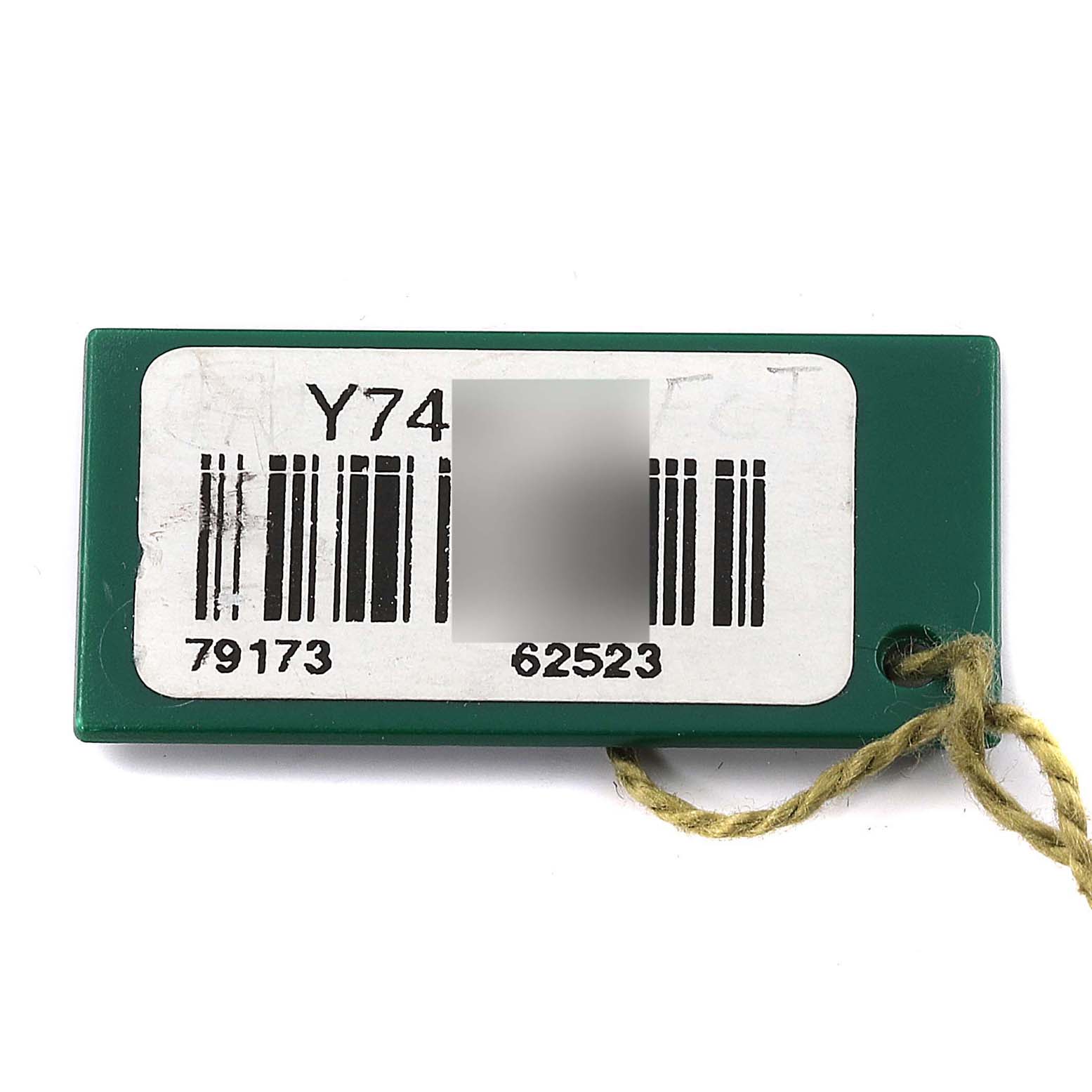 This is a close-up of a green tag with barcodes and numbers, belonging to a Rolex Datejust 79173 Women's Steel and Gold (two tone) Mother of Pearl Dial 79173 Women's Steel and Gold (two tone) Mother of Pearl Dial model watch.