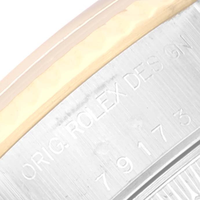 This close-up image shows the engraved details on the side of the bezel of a Rolex Datejust 79173 Women's Steel and Gold (two tone) Mother of Pearl Dial 79173 Women's Steel and Gold (two tone) Mother of Pearl Dial watch.