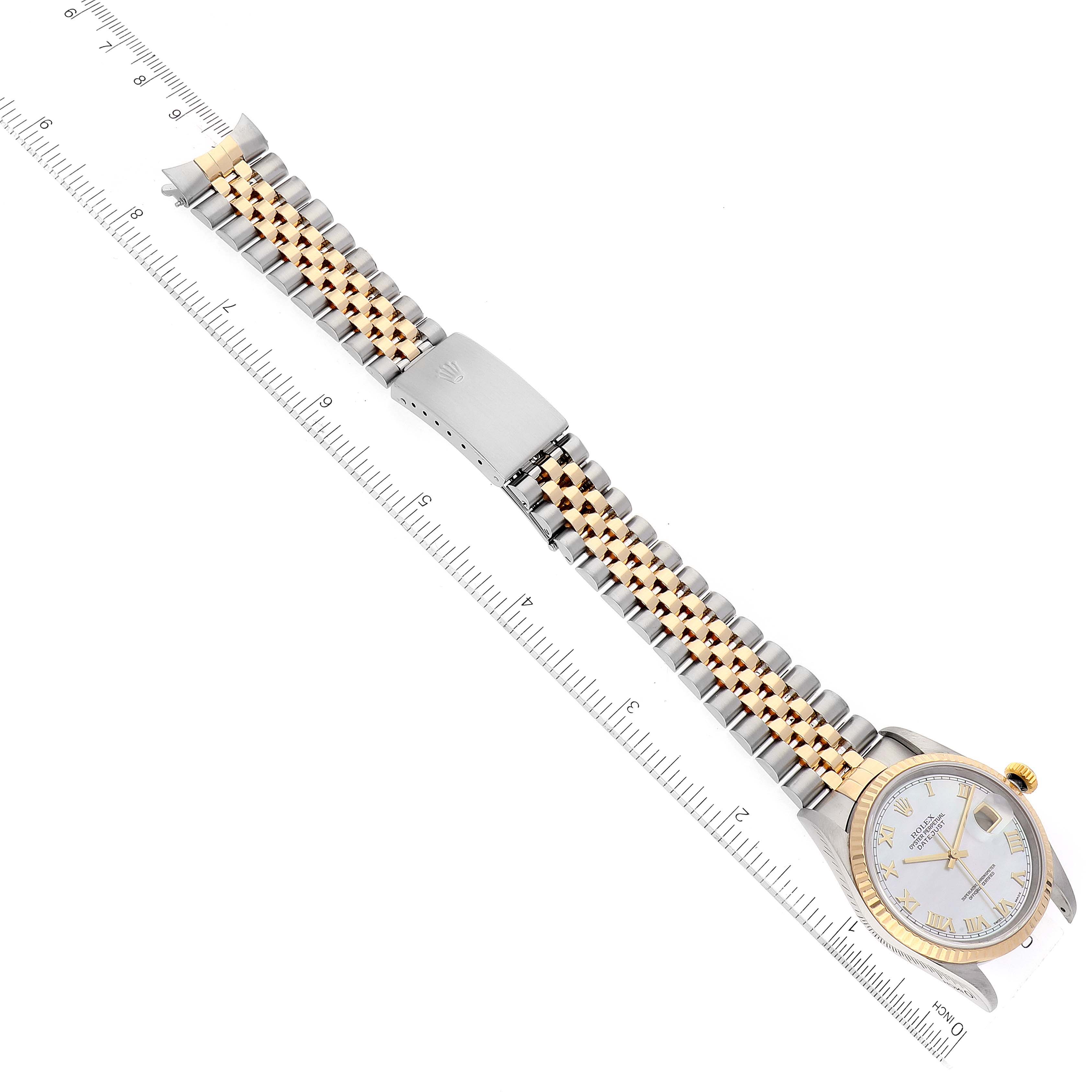 This image shows the Rolex Datejust 16233 Men's Steel and Gold (two tone) Mother of Pearl Dial 16233 Men's Steel and Gold (two tone) Mother of Pearl Dial watch laid flat, featuring the watch face and the full Jubilee bracelet with a ruler for scale.