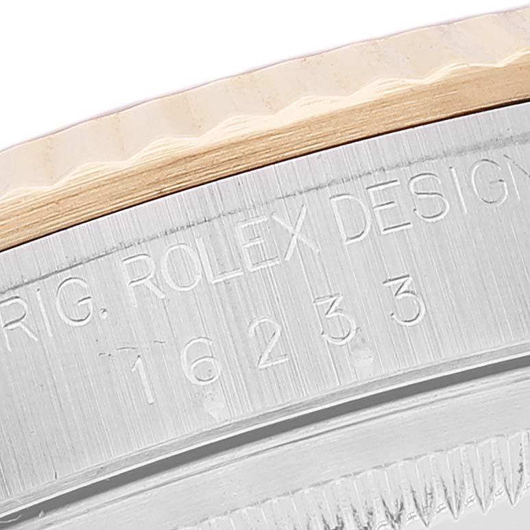 The image shows a close-up angle of the side engraving and fluted bezel of the Rolex Datejust 16233 Men's Steel and Gold (two tone) Mother of Pearl Dial 16233 Men's Steel and Gold (two tone) Mother of Pearl Dial model.