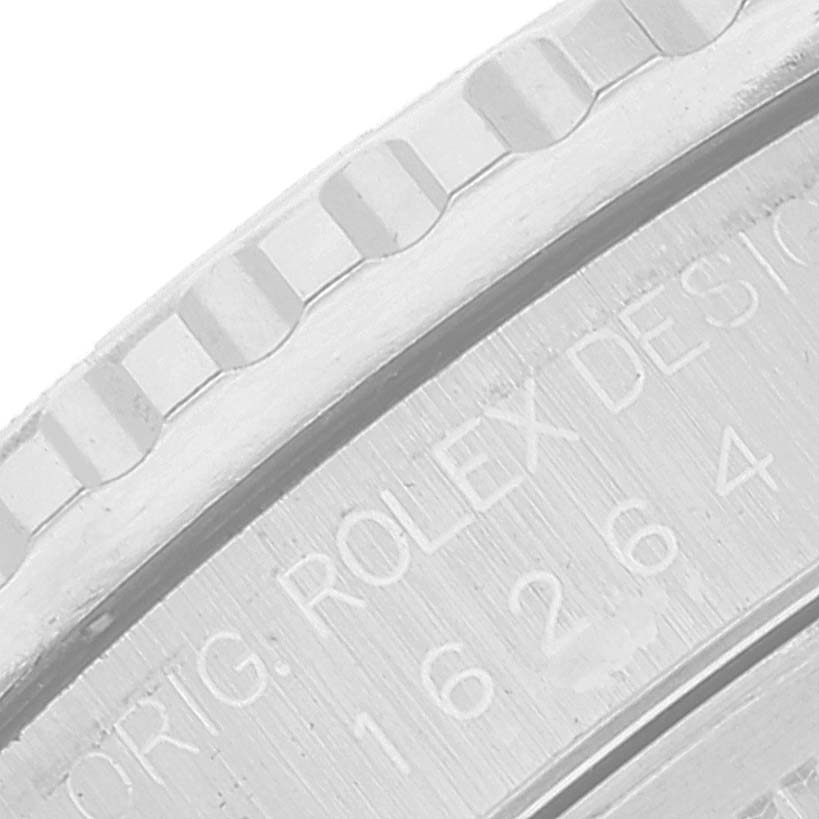 This image shows a close-up of the bezel and part of the engraved case back inscription of a Rolex Turn-o-Graph 16264 Men's Stainless Steel Silver Dial 16264 Men's Stainless Steel Silver Dial watch.