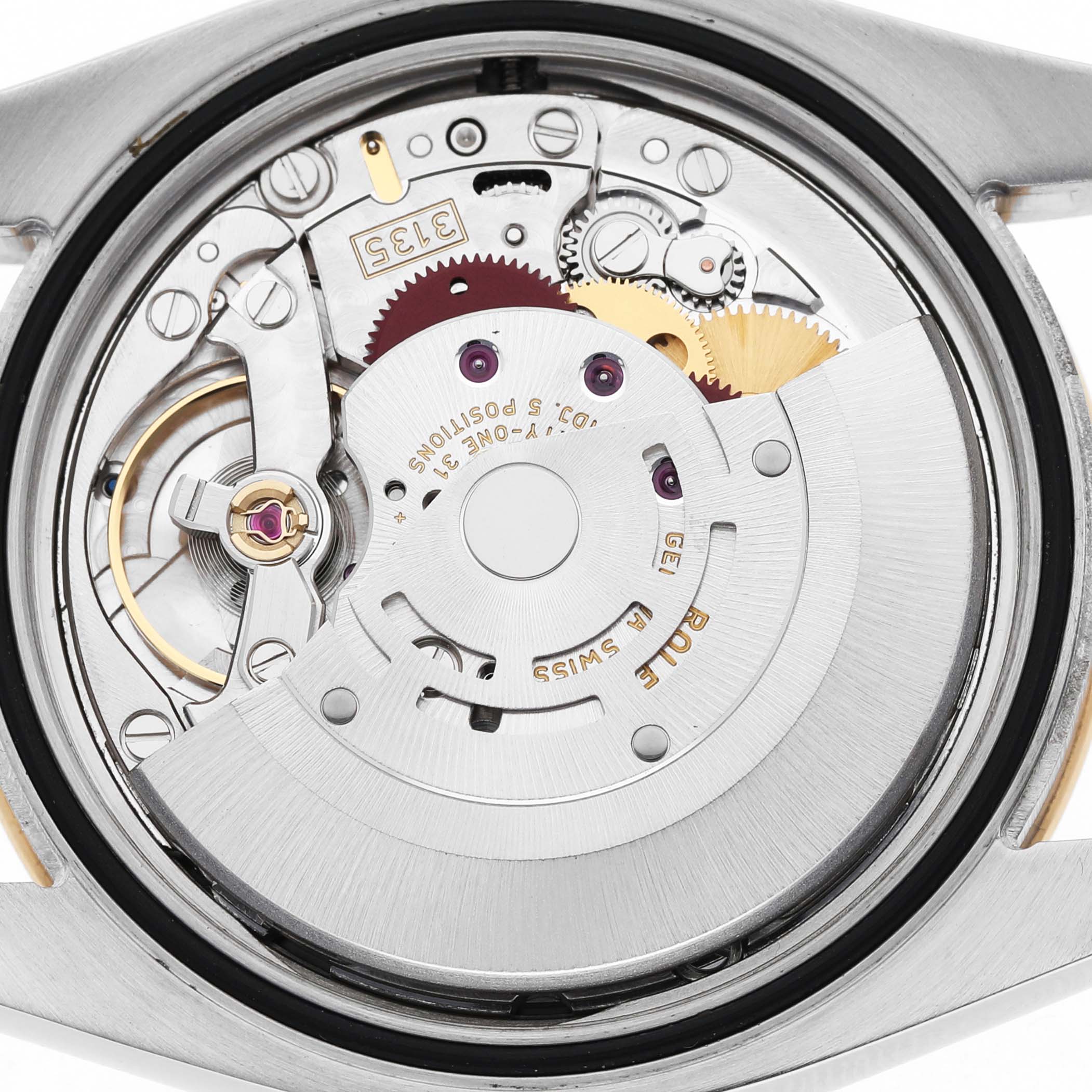 The image shows a close-up of the movement inside a Rolex Turn-o-Graph 116263 Men's Steel and Gold (two tone) Champagne Dial watch, highlighting gears and mechanical parts.
