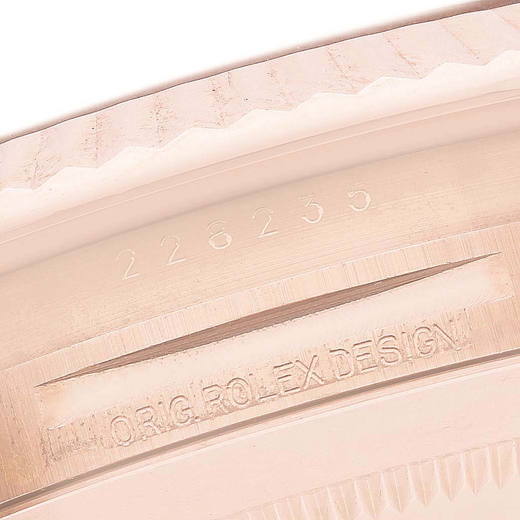 The image shows an engraving of "ORIG. ROLEX DESIGN" and "228235" on the inner ring of a Rolex President 228235 Men's Rose Gold Green Dial watch.
