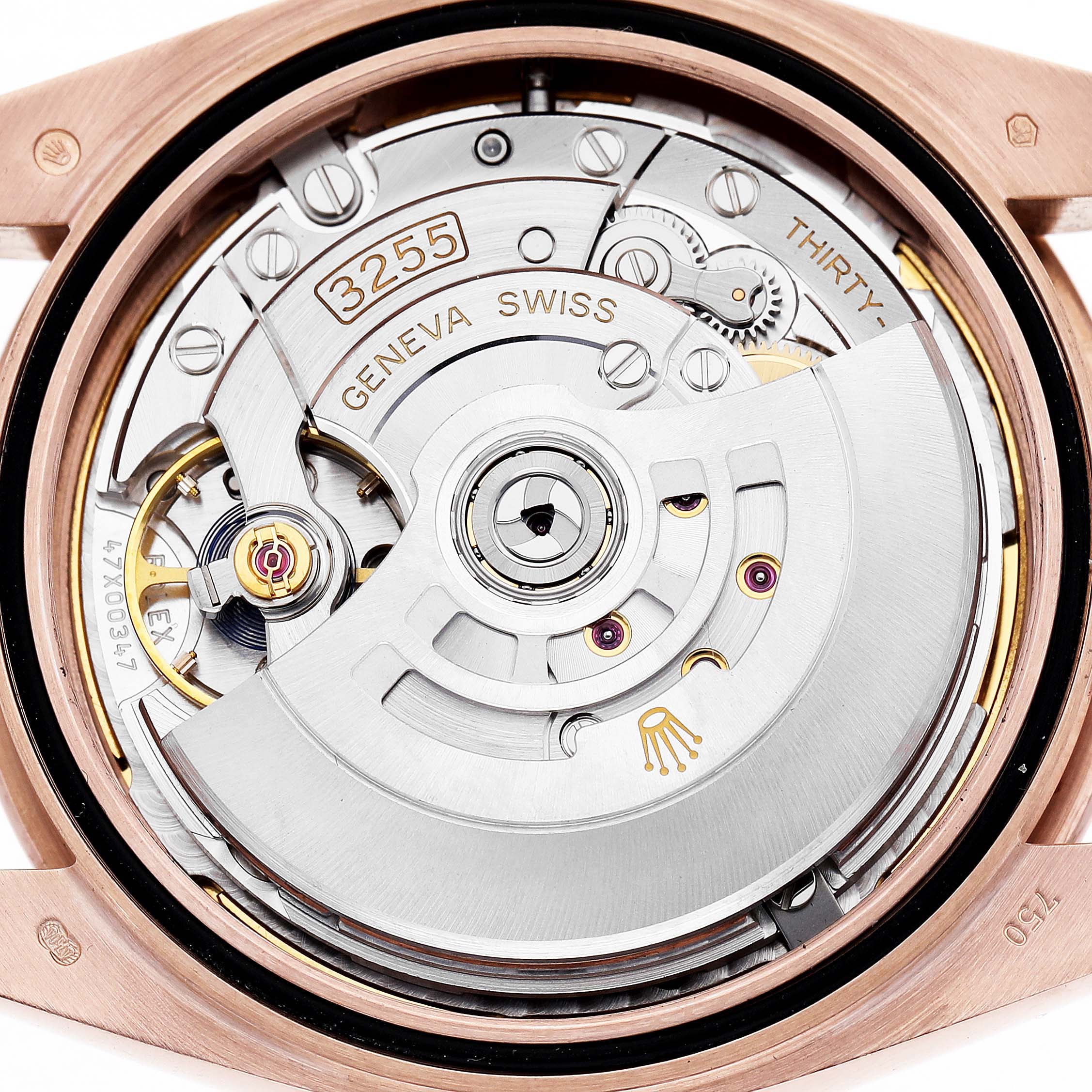 The image shows the movement mechanism of a Rolex President 228235 Men's Rose Gold Green Dial model watch from a top-down angle, revealing its intricate gears and rotor.