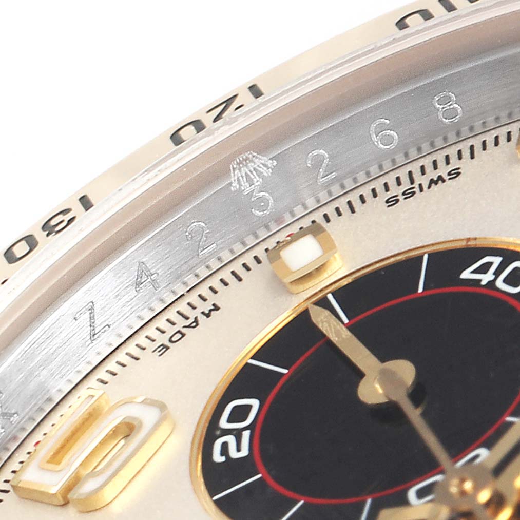 The image shows a close-up view of the bezel and part of the dial of a Rolex Daytona 116523 Men's Steel and Gold (two tone) Silver Dial 116523 Men's Steel and Gold (two tone) Silver Dial watch.