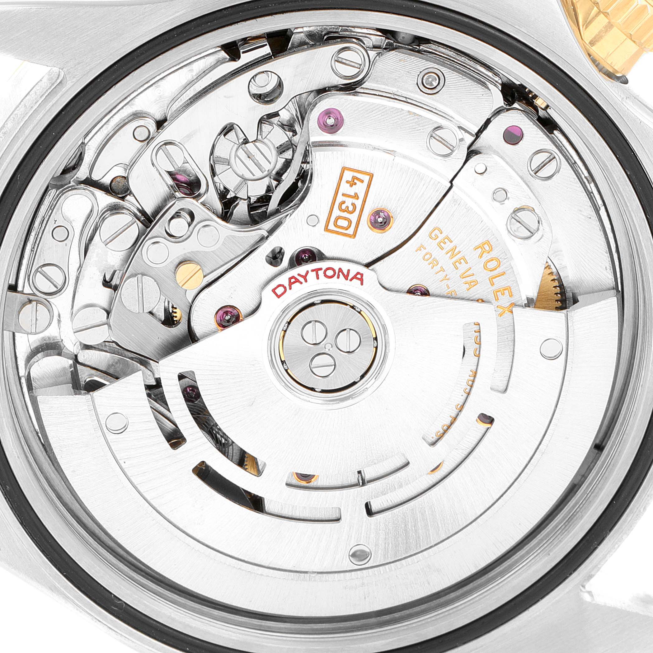 The image shows the inner mechanism of a Rolex Daytona 116523 Men
s Steel and Gold (two tone) Black Dial 116523 Men
s Steel and Gold (two tone) Black Dial watch at an angled close-up, displaying gears and the rotor.
