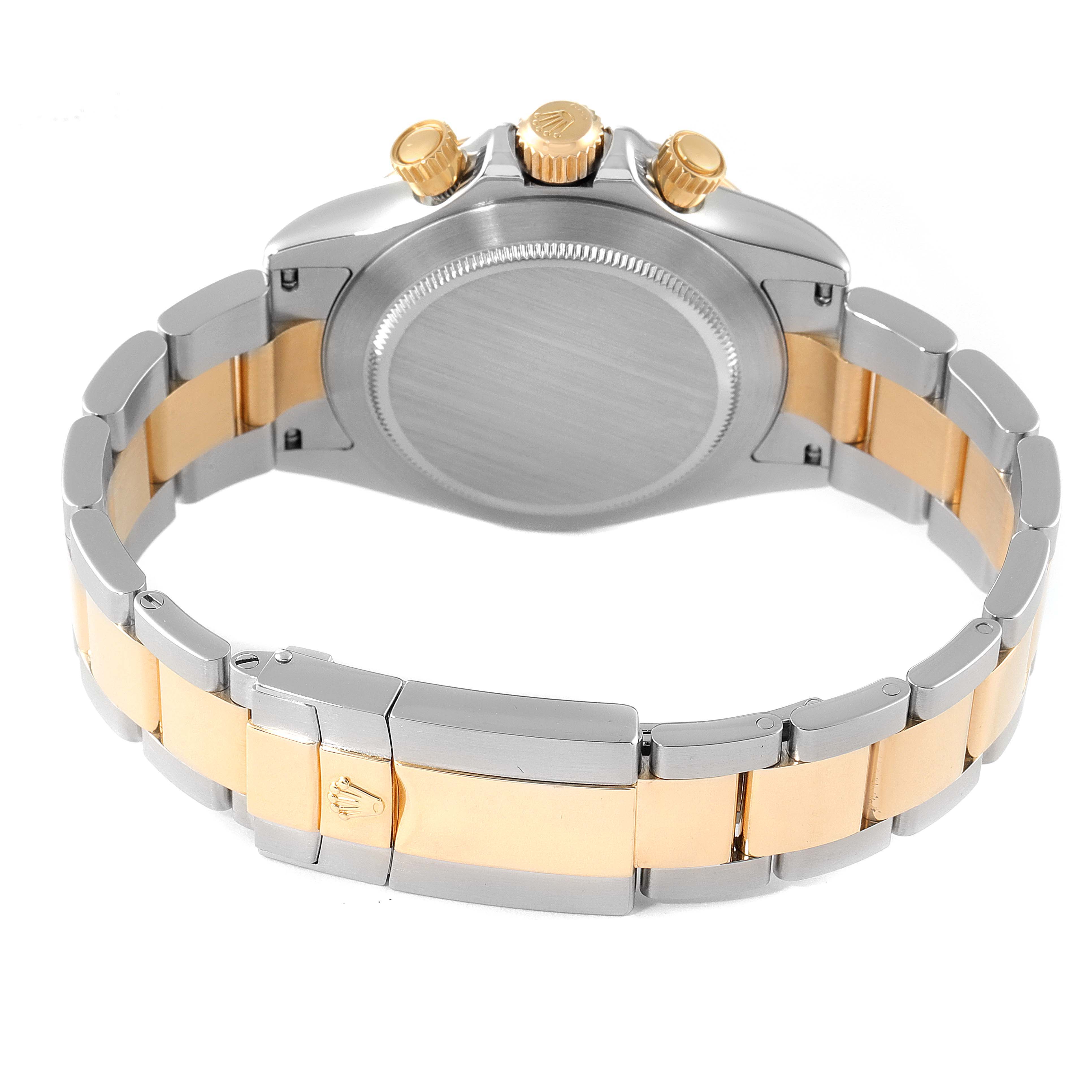 This image shows the back and clasp of a Rolex Daytona 116523 Men
s Steel and Gold (two tone) Black Dial 116523 Men
s Steel and Gold (two tone) Black Dial watch, highlighting its two-tone metal bracelet and three pushers/crown.