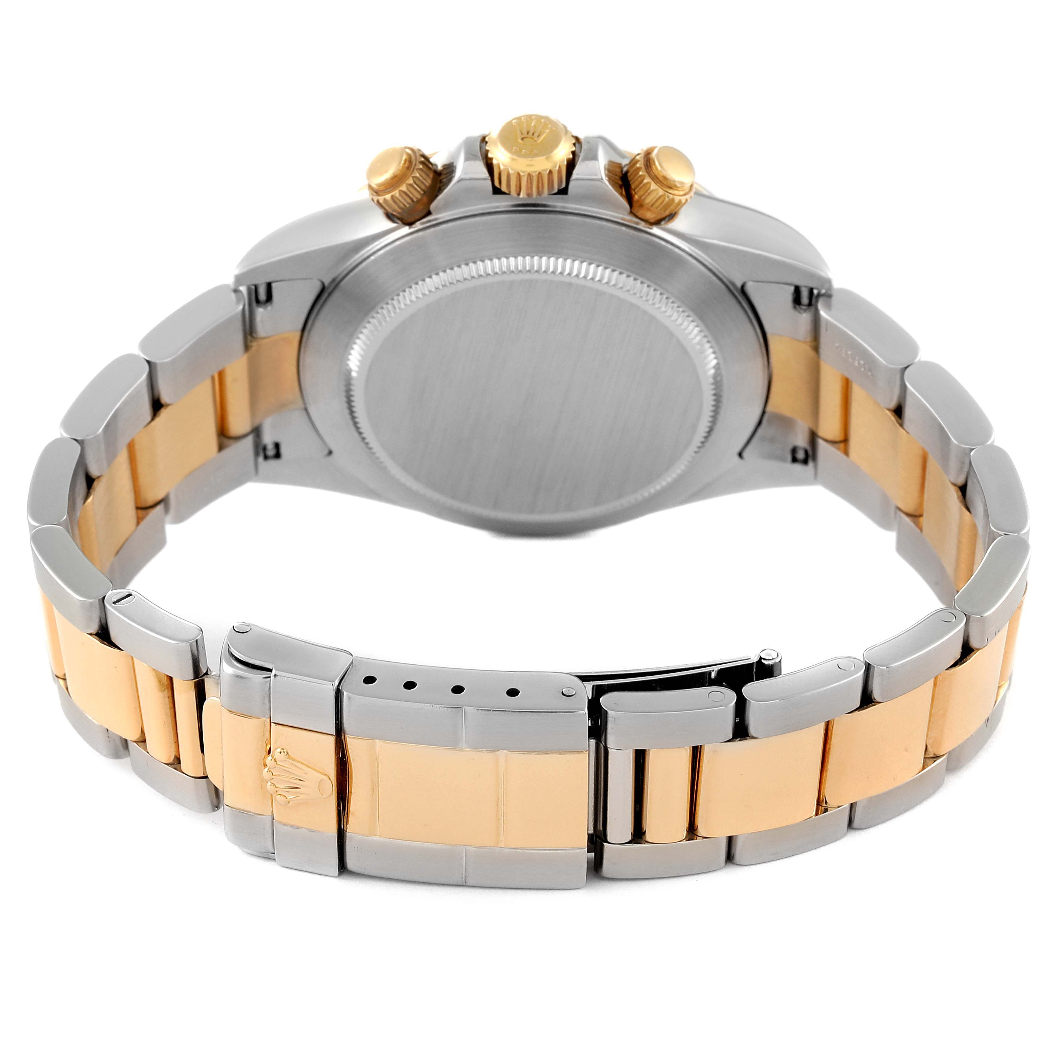 The image shows the back and side view of the Rolex Daytona 16523 Men
s Steel and Gold (two tone) White Dial 16523 Men
s Steel and Gold (two tone) White Dial
s case and two-tone bracelet.