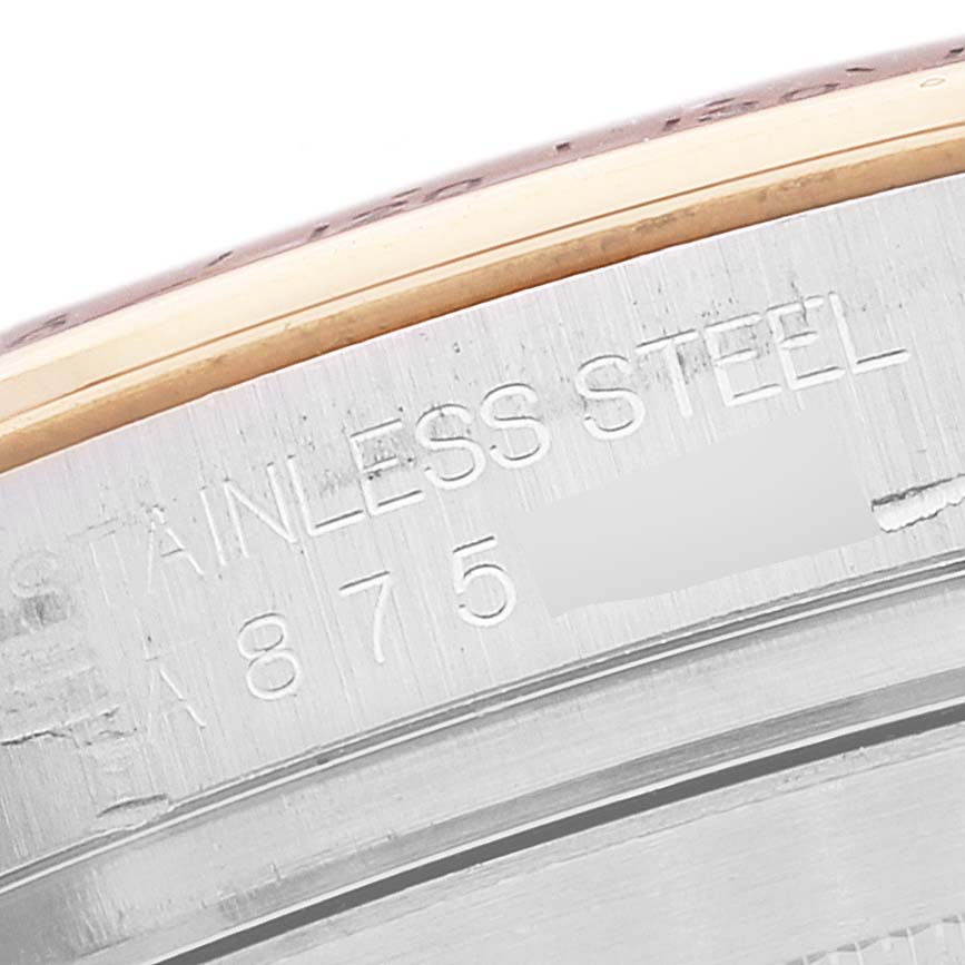 The image shows a close-up of the case back of a Rolex Daytona 16523 Men
s Steel and Gold (two tone) White Dial 16523 Men
s Steel and Gold (two tone) White Dial watch, specifically the engraved "STAINLESS STEEL" marking.