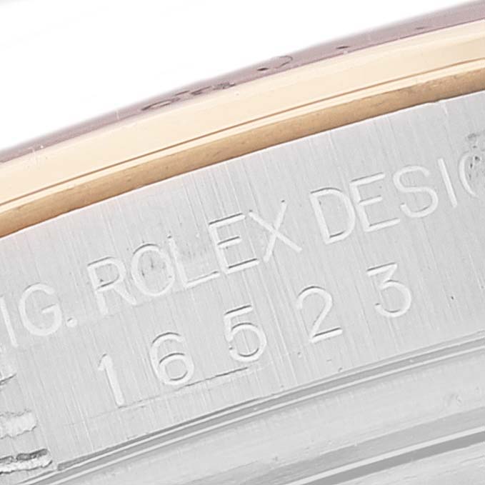 The image shows a close-up of the engraved model number "16523" on a Rolex Daytona 16523 Men
s Steel and Gold (two tone) White Dial 16523 Men
s Steel and Gold (two tone) White Dial watch case.