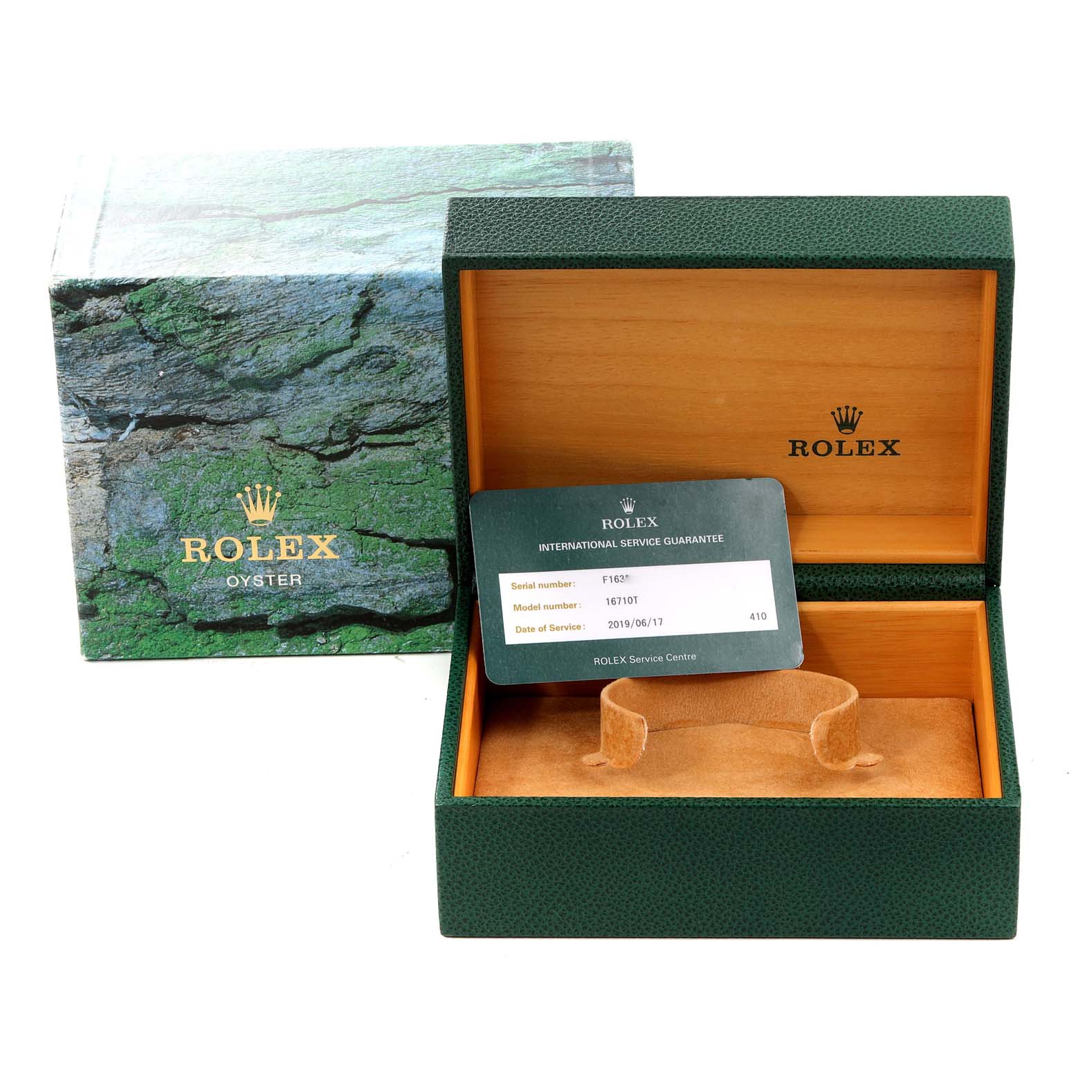 The image shows the open box for a Rolex GMT-Master 16710 Men
s Stainless Steel Black Dial 16710 Men
s Stainless Steel Black Dial watch, with the international service guarantee card visible.