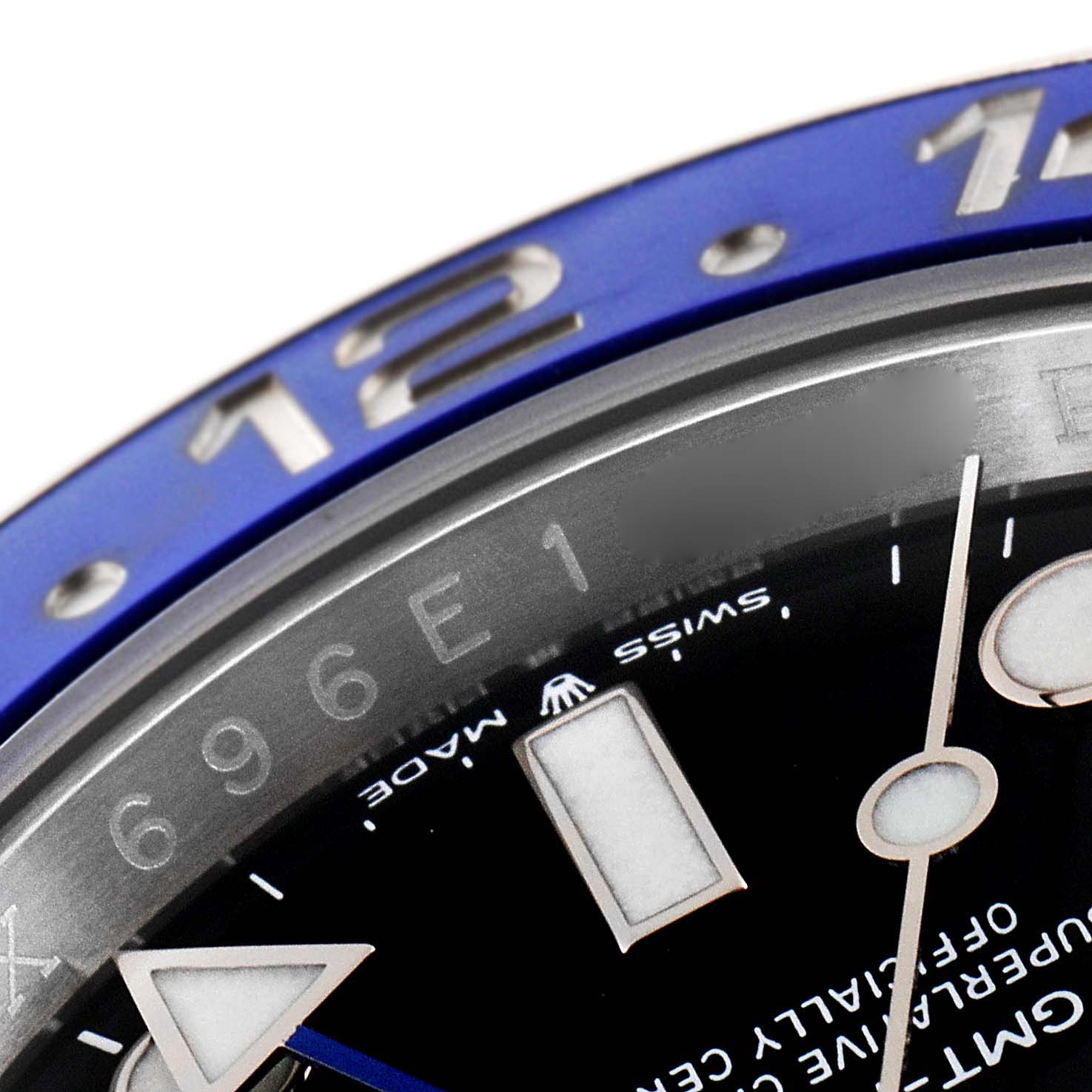 This close-up image of the Rolex GMT-Master 126710BLNR Men's Stainless Steel Black Dial 126710BLNR Men's Stainless Steel Black Dial watch shows part of the bezel, dial, and some hour markers.