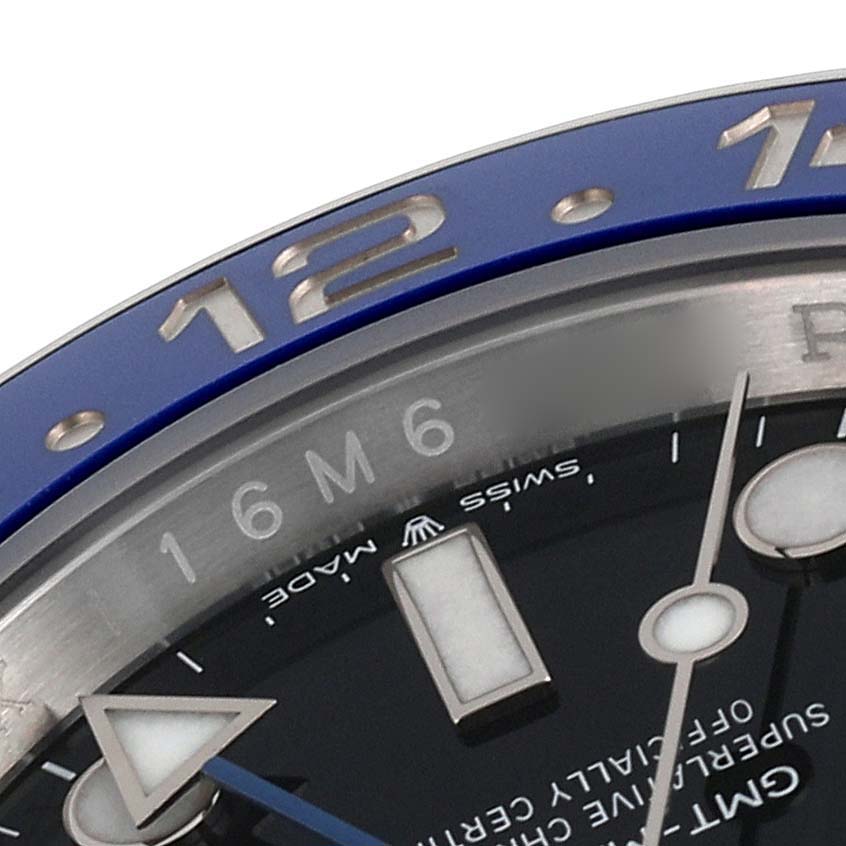 The image shows a close-up of the top half of a Rolex GMT-Master 126710 Men's Stainless Steel Black Dial 126710 Men's Stainless Steel Black Dial watch, highlighting the bezel, hour markers, and part of the dial.