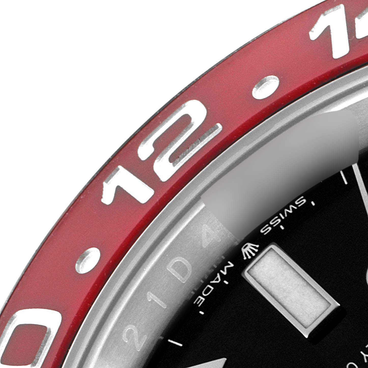 The image shows a close-up of the bezel and part of the dial of a Rolex GMT-Master 126710 Men
s Stainless Steel Black Dial 126710 Men
s Stainless Steel Black Dial watch, highlighting the "12" marker.