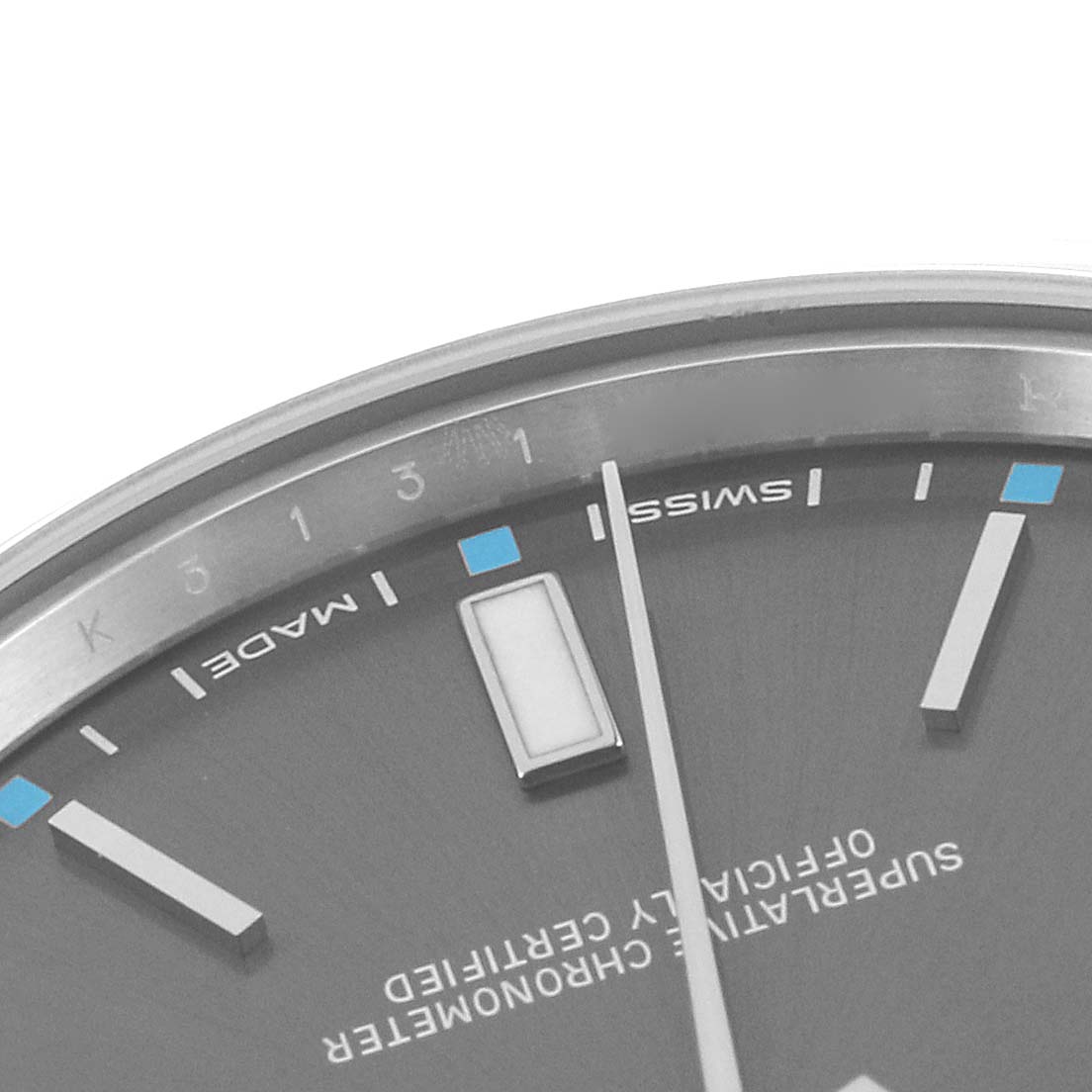 This image shows a close-up of the dial and minute hand of the Rolex Oyster Perpetual 114300 Men
s Stainless Steel Grey Dial 114300 Men
s Stainless Steel Grey Dial watch, highlighting the "Swiss Made" text.